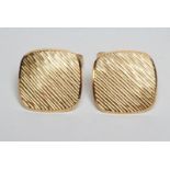 A PAIR OF MODERN CUFFLINKS of rounded square section with brushed bark effect finish and engine