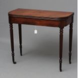 A REGENCY MAHOGANY FOLDING TEA TABLE of rounded oblong form with reeded edged top, plain frieze with