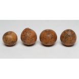 FOUR JAPANESE SEED PODS, late 19th century, each with black stained and engraved figures and