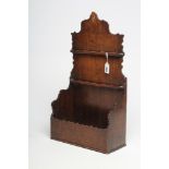 A GEORGIAN OAK HANGING SPOON RACK, c.1800, the arched fretwork back with two racks over open box