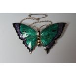 A SILVER AND ENAMEL BUTTERFLY BROOCH, maker's mark C&H, Birmingham 1918, with green and dark lilac