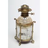 A VICTORIAN BRASS AND GLASS PATENT OIL LAMP of cylindrical form, the pierced brass fitting with