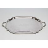 A SILVER TWO HANDLED TEA TRAY, maker's mark HP & S, Birmingham 1934, of oblong form with re-