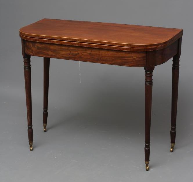 A GEORGIAN MAHOGANY FOLDING TEA TABLE, c.1800, of rounded oblong form with rosewood banding and