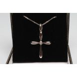 AN 18CT WHITE GOLD CROSS PENDANT, centred by a collet set brilliant cut diamond and sapphire, on