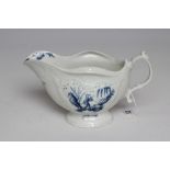 A FIRST PERIOD WORCESTER PORCELAIN SAUCEBOAT, c.1765, of lobed oval form with scroll moulded