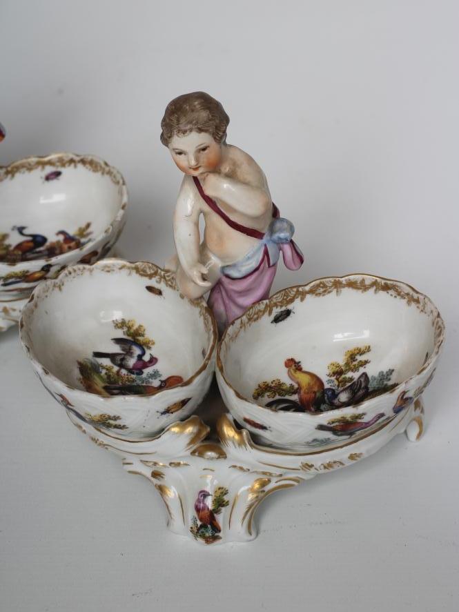 A PAIR OF BERLIN PORCELAIN FIGURAL SALTS, late 19th century, each modelled as a putto standing - Image 2 of 3