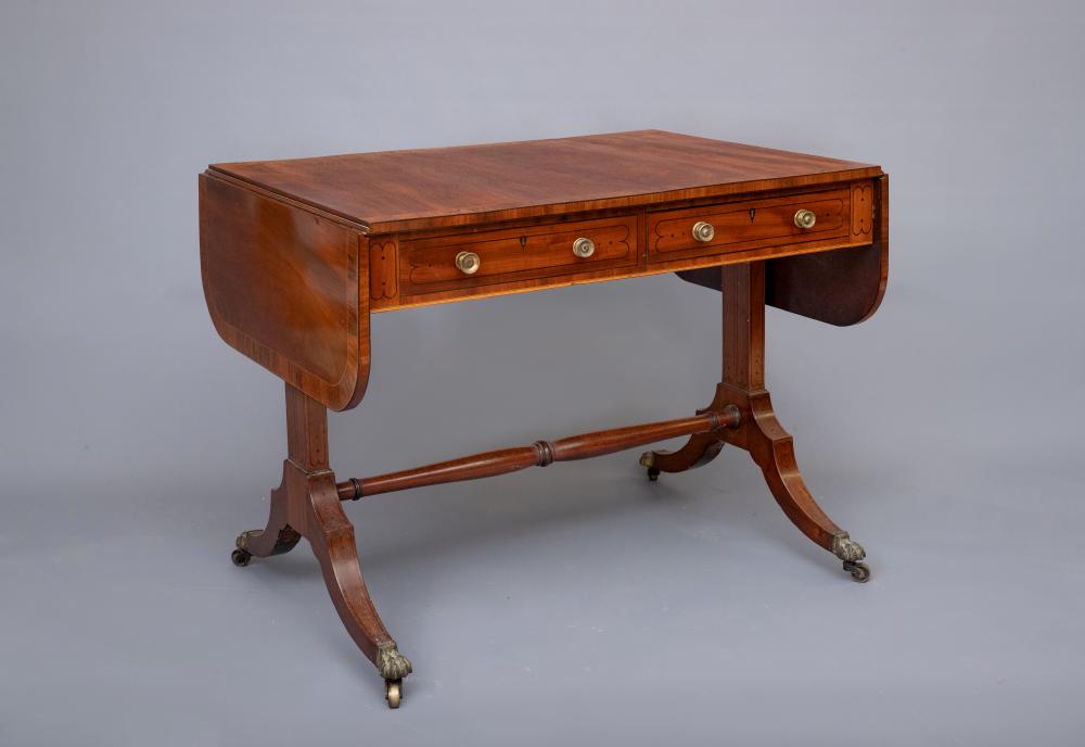 A REGENCY MAHOGANY AND ROSEWOOD BANDED SOFA TABLE, of rounded oblong form with ebony stringing,