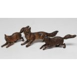 THREE VIENNA STYLE BRONZE FOXES, all cold painted and unmarked, 5 3/4" x 4 3/4" long (Est. plus