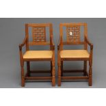 A PAIR OF ROBERT THOMPSON ADZED OAK ELBOW CHAIRS, 1950's, the tapering backs with pierced lattice