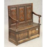 A GEORGIAN SMALL JOINED OAK BOX SETTLE, late 18th century, the triple fielded panel back later