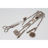 A LATE VICTORIAN SILVER CHATELAINE, maker Charles Boyton, London 1889, the cast open scroll belt