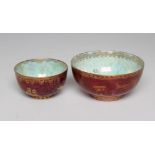 TWO GRADUATED WEDGWOOD BUTTERFLY LUSTRE BOWLS with gilt printed mottled puce ground and iridescent