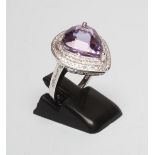 AN AMETHYST AND DIAMOND DRESS RING, the pear cut amethyst of approximately 6.33cts collet set to a