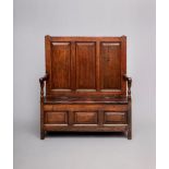 A GEORGIAN SMALL JOINED OAK BOX SETTLE, late 18th century, the high back with three fielded panels