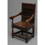A JOINED OAK ARMCHAIR, late 17th century and later, the panelled back carved with arcading over a