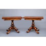 A PAIR OF EARLY VICTORIAN ROSEWOOD FOLDING TEA TABLES, the rounded oblong swivel top, panelled