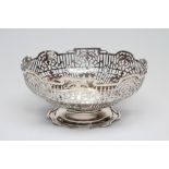 A SILVER FRUIT BOWL, maker Walker & Hall, Sheffield 1935, of circular form with shaped rim enclosing