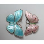 TWO SILVER AND ENAMEL BUTTERFLY BROOCHES, one with pale pink wings with red dot markings and a green
