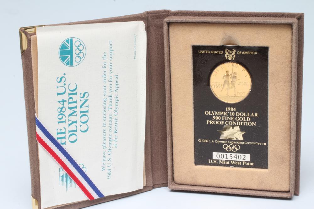 A 1984 OLYMPIC PROOF GOLD $10, shrink wrapped onto certificate, number 0015402, cased and boxed (