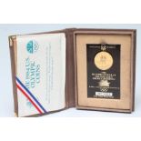 A 1984 OLYMPIC PROOF GOLD $10, shrink wrapped onto certificate, number 0015402, cased and boxed (