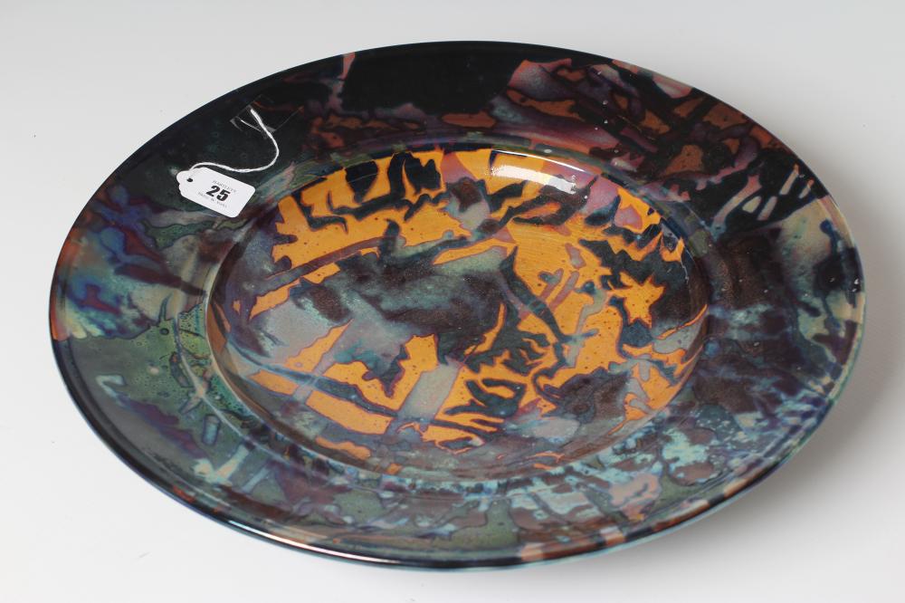 SUTTON TAYLOR (b.1943), a studio pottery charger of dished circular form decorated in abstract