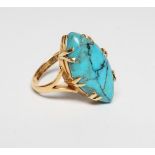 AN ARTS AND CRAFTS DRESS RING, the cabochon polished eliptical turquoise matrix claw set to open