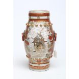 A JAPANESE PORCELAIN VASE of bombe cylindrical form with two fixed ring and rosette handles, painted