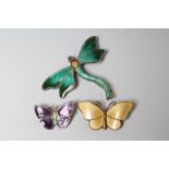 A STERLING SILVER AND ENAMEL DRAGONFLY BROOCH with green wings and tail and yellow thorax, 1 3/4"