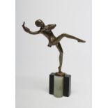 AFTER LORENZL - an Art Deco bronzed spelter figure of a dancing girl balancing on her left leg,