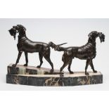 AN ART DECO BRONZED METAL GROUP of a retriever and a setter, each holding game in its mouth, and
