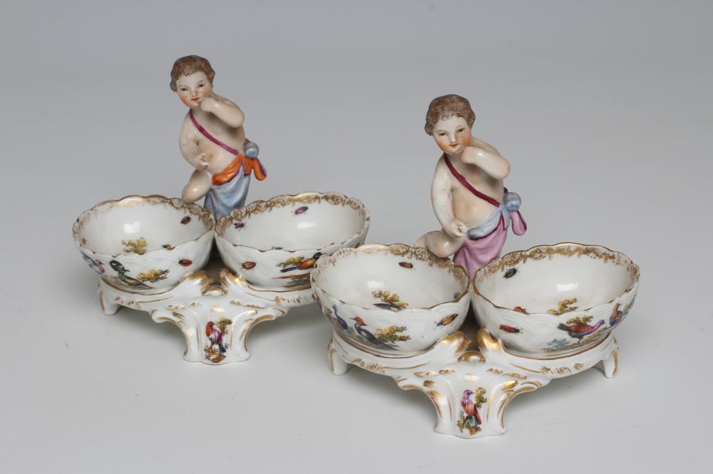 A PAIR OF BERLIN PORCELAIN FIGURAL SALTS, late 19th century, each modelled as a putto standing