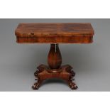 A VICTORIAN ROSEWOOD FOLDING TEA TABLE of rounded oblong form with swivel top, faceted baluster stem