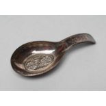 A LATE GEORGE III SILVER CADDY SPOON, maker Samuel Pemberton, Birmingham 1802, with bright cut