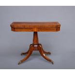 A REGENCY ROSEWOOD FOLDING CARD TABLE, early 19th century, of canted oblong form with stringing,