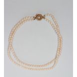 A DOUBLE STRAND CULTURED PEARL NECKLACE, the seventy three and sixty five pearls on an 18ct gold