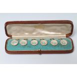 A SET OF SIX SHIRT STUDS, the circular mother of pearl panels centred by a turquoise bead within a