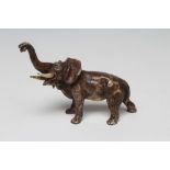 A BERGMAN BRONZE ELEPHANT, standing with head uplifted and extended trunk, urn mark to underside,