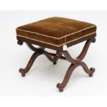 A REGENCY MAHOGANY X FRAMED STOOL of square form, upholstered in brown dralon with reeded seat