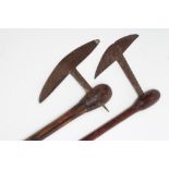 TWO ZULU AXES, one possibly late 19th century, with 8 1/2" blade and 25" hardwood shaft, the other