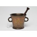 A BRONZE MORTAR, 18th century, of tapering form with moulded banding, plain loop handles and