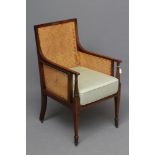 AN EDWARDIAN MAHOGANY AND CANED BERGERE with stringing, straight top rail, straight arms on turned