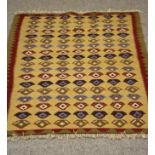 A SMALL PERSIAN TRIBAL RUG, the red field with two guls in navy blue and ivory, star decorated