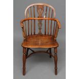 A YEW WINDSOR ARMCHAIR, 19th century, of low hoop back form with shaped and pierced splat,