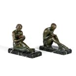 BY AND AFTER PIERRE LE FAGUAYS (1892-1962) - a pair of art deco bronze figural bookends cast as a