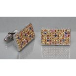 A PAIR OF SILVER CUFFLINKS, each oblong panel pave set with numerous multi-coloured sapphires,