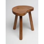 AN ADZED OAK STOOL by Robert Thompson, the kidney shaped seat with carved mouse trademark in high