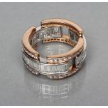 AN UNUSUAL HINGED DIAMOND RING, with three plaques channel set with graduated baguette cut stones
