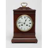 A MAHOGANY CASED TABLE CLOCK, the twin barrel movement striking on a gong, the white enamel dial