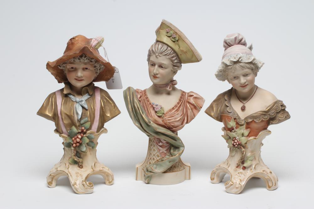 A ROYAL DUX SMALL BUST, early 20th century, the young lady wearing a green tricorn hat and flower